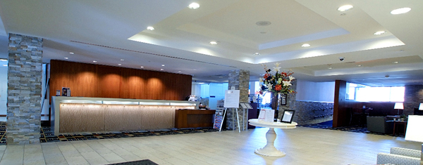 Lobby with recessed ceiling lighting and illuminated reception desk